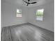 Bright bedroom with modern ceiling fan and light gray laminate flooring at 5730 66Th Ln N, St Petersburg, FL 33709