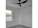 Bedroom showing a window, closet, and dark ceiling fan at 5730 66Th Ln N, St Petersburg, FL 33709