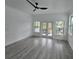 Large bedroom with balcony, wood-look flooring and neutral paint throughout at 5730 66Th Ln N, St Petersburg, FL 33709
