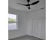 Bright bedroom with ceiling fan, window, and closet space at 5730 66Th Ln N, St Petersburg, FL 33709
