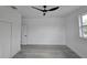 A bright bedroom with a modern ceiling fan and wood-look flooring at 5730 66Th Ln N, St Petersburg, FL 33709