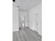 Hallway featuring gray wood look floors and white trim at 5730 66Th Ln N, St Petersburg, FL 33709
