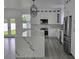 Bright kitchen features white cabinets, stainless steel appliances, gray flooring and a large center island at 5730 66Th Ln N, St Petersburg, FL 33709
