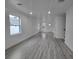 Bright, expansive living room featuring wood floors, recessed lighting, and large windows at 5730 66Th Ln N, St Petersburg, FL 33709