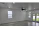 Bright living room featuring a ceiling fan and access to the backyard at 5730 66Th Ln N, St Petersburg, FL 33709