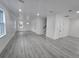 Bright, expansive living room featuring wood floors, recessed lighting, stairs and large windows at 5730 66Th Ln N, St Petersburg, FL 33709
