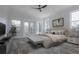 This staged main bedroom features a large bed, decor and plenty of sunlight at 5730 66Th Ln N, St Petersburg, FL 33709
