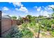 The backyard features tropical landscaping, a privacy fence, and mature trees at 6154 36Th N Ave, St Petersburg, FL 33710