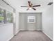 Bedroom features a ceiling fan, neutral carpet, and a large window offering natural light at 6154 36Th N Ave, St Petersburg, FL 33710