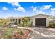 Charming single-story home featuring a well-manicured front yard with a driveway and attached garage at 6154 36Th N Ave, St Petersburg, FL 33710
