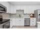 Well-equipped kitchen showcasing updated appliances and backsplash at 6154 36Th N Ave, St Petersburg, FL 33710