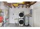 A compact utility room with a stacked washer/dryer and water heater at 6154 36Th N Ave, St Petersburg, FL 33710