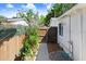 The home's side yard with wooden fences, a concrete walkway, and lush landscaping at 6154 36Th N Ave, St Petersburg, FL 33710