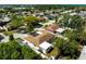 An aerial view shows this well maintained single Gathering home with mature landscaping and a screened-in lanai at 6311 Seabreeze Dr, Port Richey, FL 34668