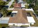 Aerial view of the home featuring a fenced backyard and a covered and screened-in patio at 6311 Seabreeze Dr, Port Richey, FL 34668