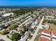 An aerial view shows this active neighborhood featuring mature trees and various home styles near the coast at 6311 Seabreeze Dr, Port Richey, FL 34668