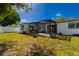 A spacious backyard featuring a pergola patio and a white privacy fence at 6311 Seabreeze Dr, Port Richey, FL 34668