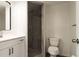 Modern bathroom featuring a vanity with stone countertops and a tiled shower at 6311 Seabreeze Dr, Port Richey, FL 34668