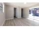 Bright bedroom featuring wood-look floors and sliding doors to outdoor patio at 6311 Seabreeze Dr, Port Richey, FL 34668