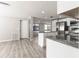 Modern eat-in kitchen features white cabinets, stainless steel appliances and a granite island counter at 6311 Seabreeze Dr, Port Richey, FL 34668