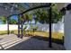 An outdoor patio featuring a black metal pergola at 6311 Seabreeze Dr, Port Richey, FL 34668