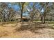 Expansive backyard featuring mature trees and a screened-in lanai at 6718 Watson Rd, Riverview, FL 33578