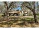 The backyard offers plenty of space, mature trees, and a screened-in porch at 6718 Watson Rd, Riverview, FL 33578