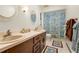 Bathroom features double sinks, a vanity, and decorative shower curtain at 6718 Watson Rd, Riverview, FL 33578