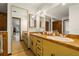 Bathroom featuring tiled vanity with double sinks, large mirror, and tile floor at 6718 Watson Rd, Riverview, FL 33578