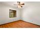 Bedroom with hardwood floors, ceiling fan, and window views of the exterior at 6718 Watson Rd, Riverview, FL 33578