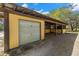 Equestrian facility with workshop and stable structure featuring a garage door and stalls at 6718 Watson Rd, Riverview, FL 33578