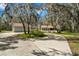 Charming home with a long driveway and mature trees covered in Spanish moss, adjacent to a separate two car garage at 6718 Watson Rd, Riverview, FL 33578