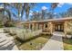 Beautiful exterior view of a stone accented home with mature landscaping, including planted flower beds at 6718 Watson Rd, Riverview, FL 33578