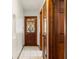 Hallway features a glass-paneled front door, tile flooring, and wood trim at 6718 Watson Rd, Riverview, FL 33578