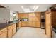 Bright kitchen features light wood cabinetry, tile flooring, stainless steel appliances, and a sunny skylight at 6718 Watson Rd, Riverview, FL 33578