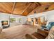 This expansive living room has wood floors, a stone fireplace, and sliding glass doors to a screened porch at 6718 Watson Rd, Riverview, FL 33578