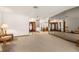 The sprawling living room features a mirrored wall, open sightlines to the dining room, and two front doors at 6718 Watson Rd, Riverview, FL 33578