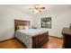 Cozy main bedroom with wood floors, ceiling fan, and natural light at 6718 Watson Rd, Riverview, FL 33578