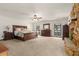 Large main bedroom boasts natural light, a ceiling fan, and a stone fireplace at 6718 Watson Rd, Riverview, FL 33578