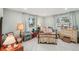 Cozy bedroom featuring natural light, traditional decor, and hardwood floors at 7094 Fairway Bend Cir # 7094, Sarasota, FL 34243