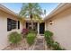 Inviting entrance featuring a palm tree, plants, and pathway to the front door at 7094 Fairway Bend Cir # 7094, Sarasota, FL 34243