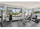 Community gym featuring weight machines and cardio equipment with bright natural light from large windows at 7094 Fairway Bend Cir # 7094, Sarasota, FL 34243