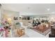 Bright and open living room featuring an island, seamlessly connecting to the kitchen and dining area at 7094 Fairway Bend Cir # 7094, Sarasota, FL 34243