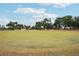 Scenic putting green with flags and lush grass, perfect for golf enthusiasts to practice their short game at 7094 Fairway Bend Cir # 7094, Sarasota, FL 34243