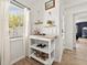 Stylish bar cart in the hall near a sunny window with a view of the outdoors at 7134 2Nd N St, St Petersburg, FL 33702