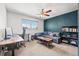 Bedroom featuring a ceiling fan, window, couch, and a small desk at 7134 2Nd N St, St Petersburg, FL 33702