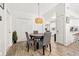 Inviting dining area featuring tile floors and modern pendant lighting, with a view to the kitchen at 7134 2Nd N St, St Petersburg, FL 33702