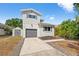 Charming home featuring a gray exterior, matching shed and an attached one-car garage at 7134 2Nd N St, St Petersburg, FL 33702