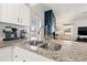 Modern kitchen with granite countertops, stainless steel sink and faucet, and white cabinetry at 7134 2Nd N St, St Petersburg, FL 33702