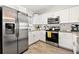 Well-lit kitchen boasting stainless steel appliances and white cabinets at 7134 2Nd N St, St Petersburg, FL 33702